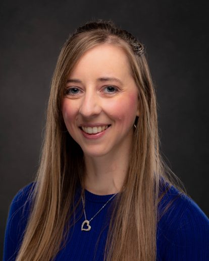 A professional headshot of Leah Corpus, who has blonde hair, light eyes, and a fair complection.